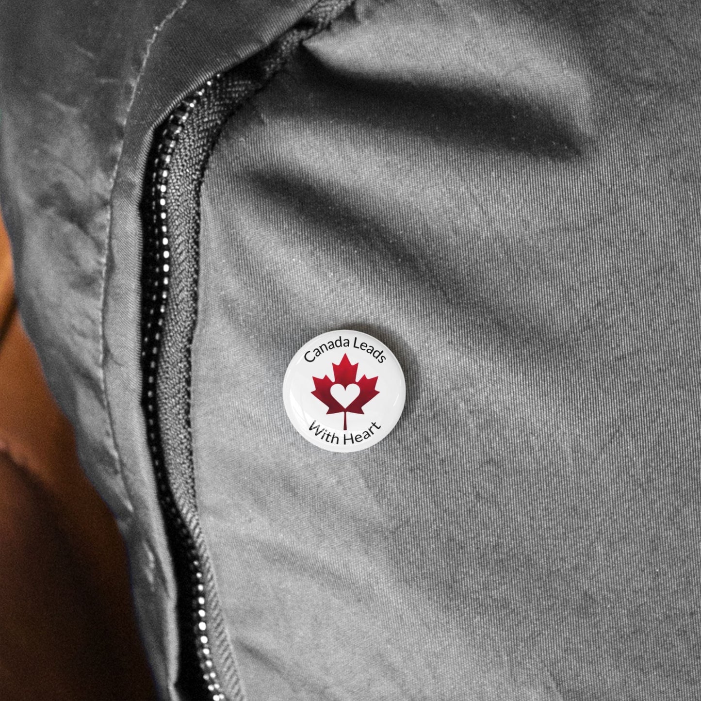 Gray jacket with a 'Canada Leads With Heart' logo on a person's chest.