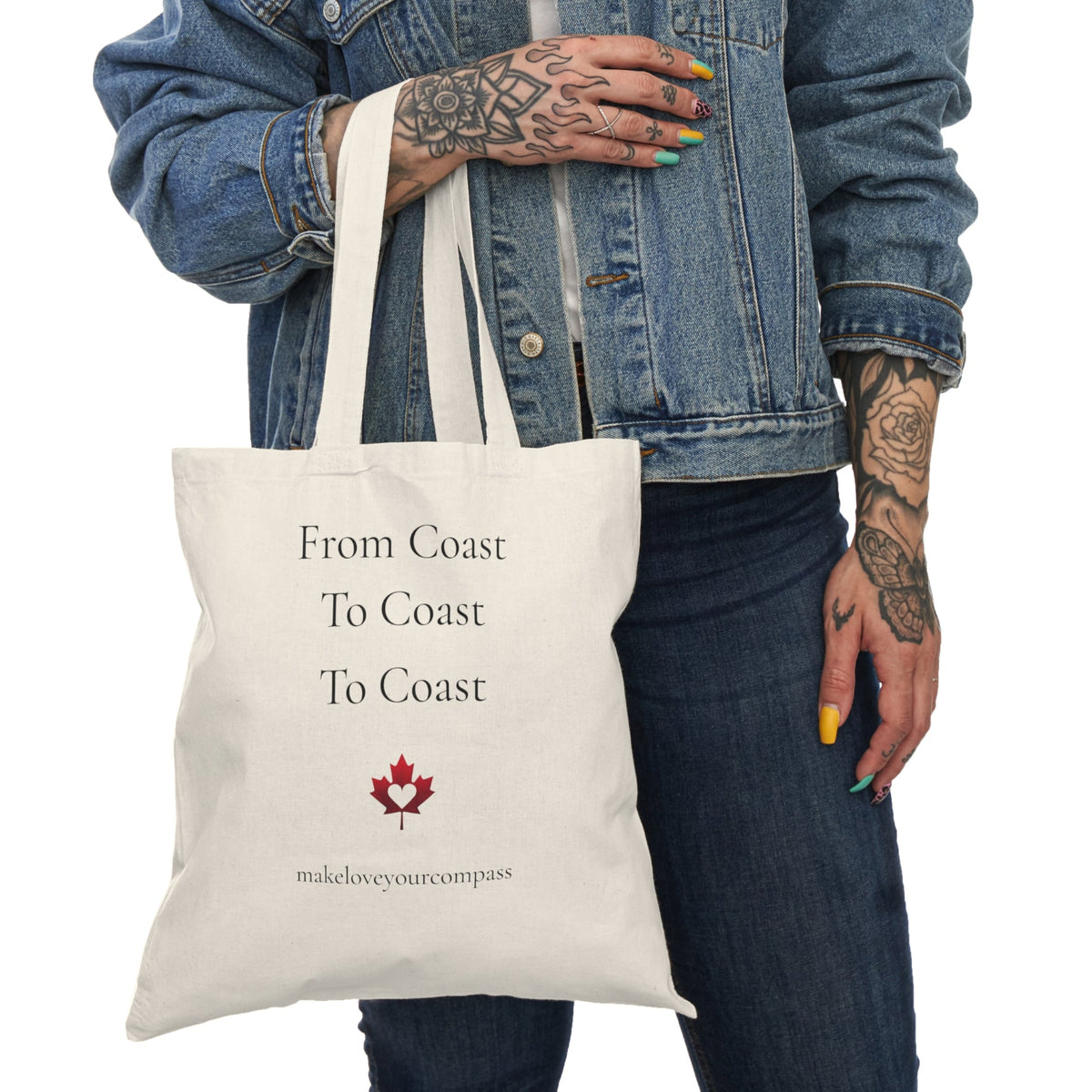 Tote bag with 'From Coast To Coast To Coast' text and a maple leaf design, held by a person wearing a denim jacket.