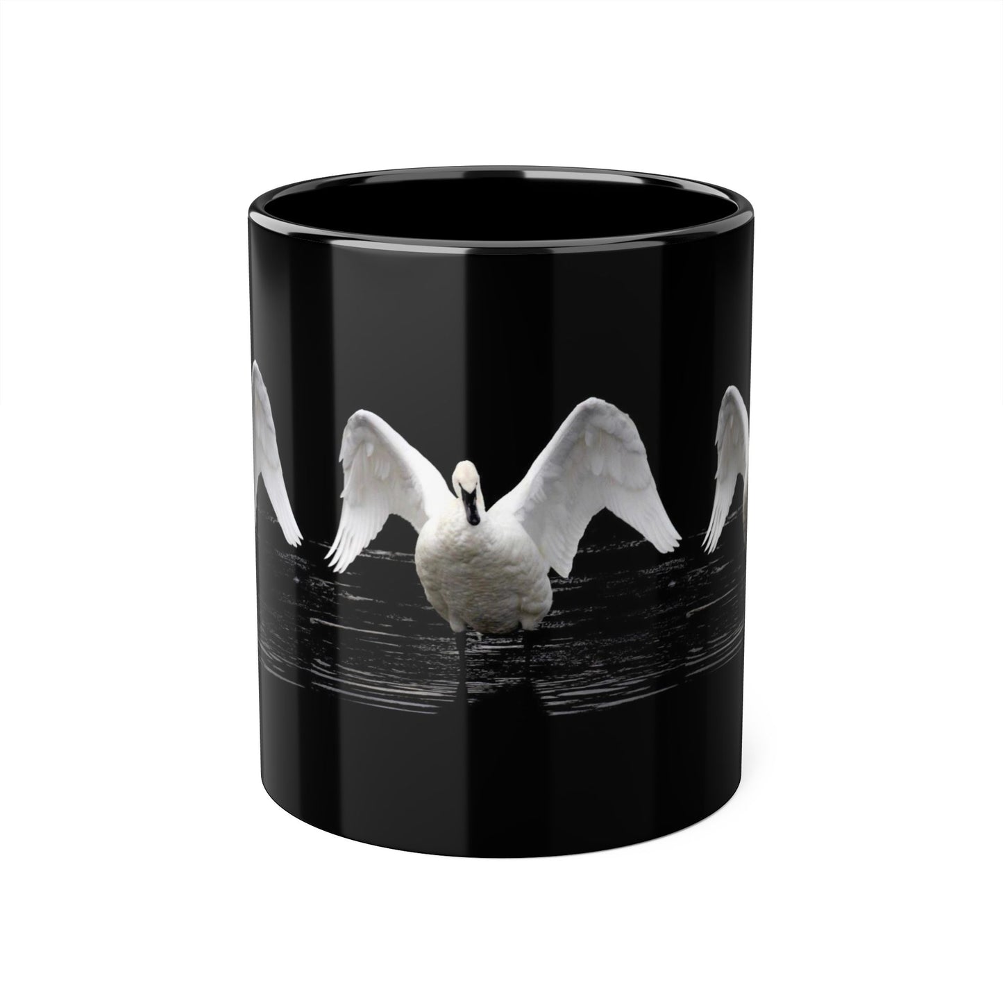 A glossy black ceramic mug featuring a printed graphic of a white swan with wings spread, set against a clean white background.