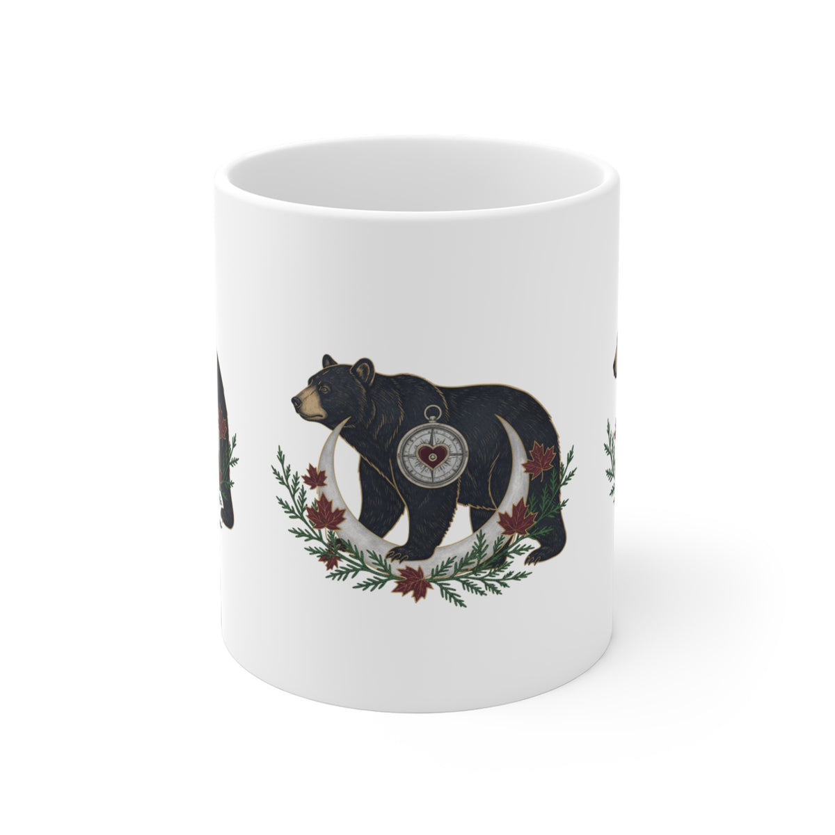  A white ceramic mug featuring a printed illustration of a black bear carrying a compass over its shoulder, surrounded by a crescent moon and small red flags in the branch.
