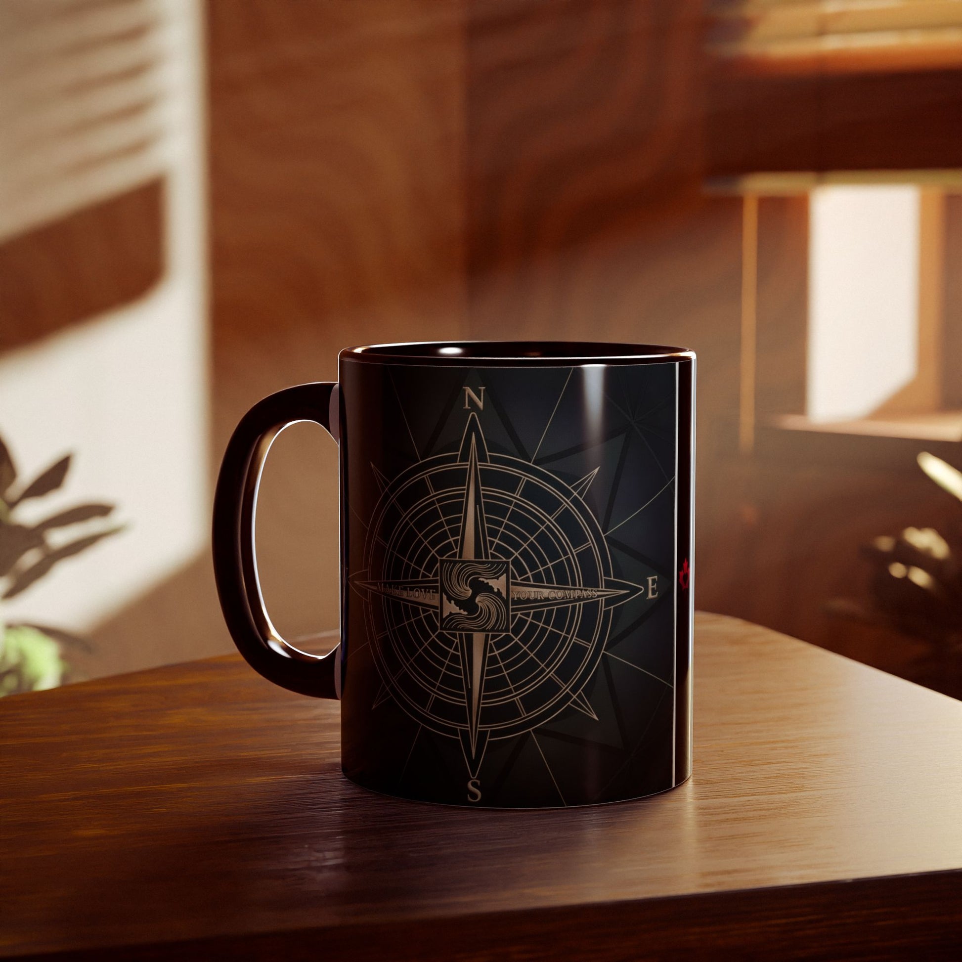 Black mug with a compass design on a wooden surface