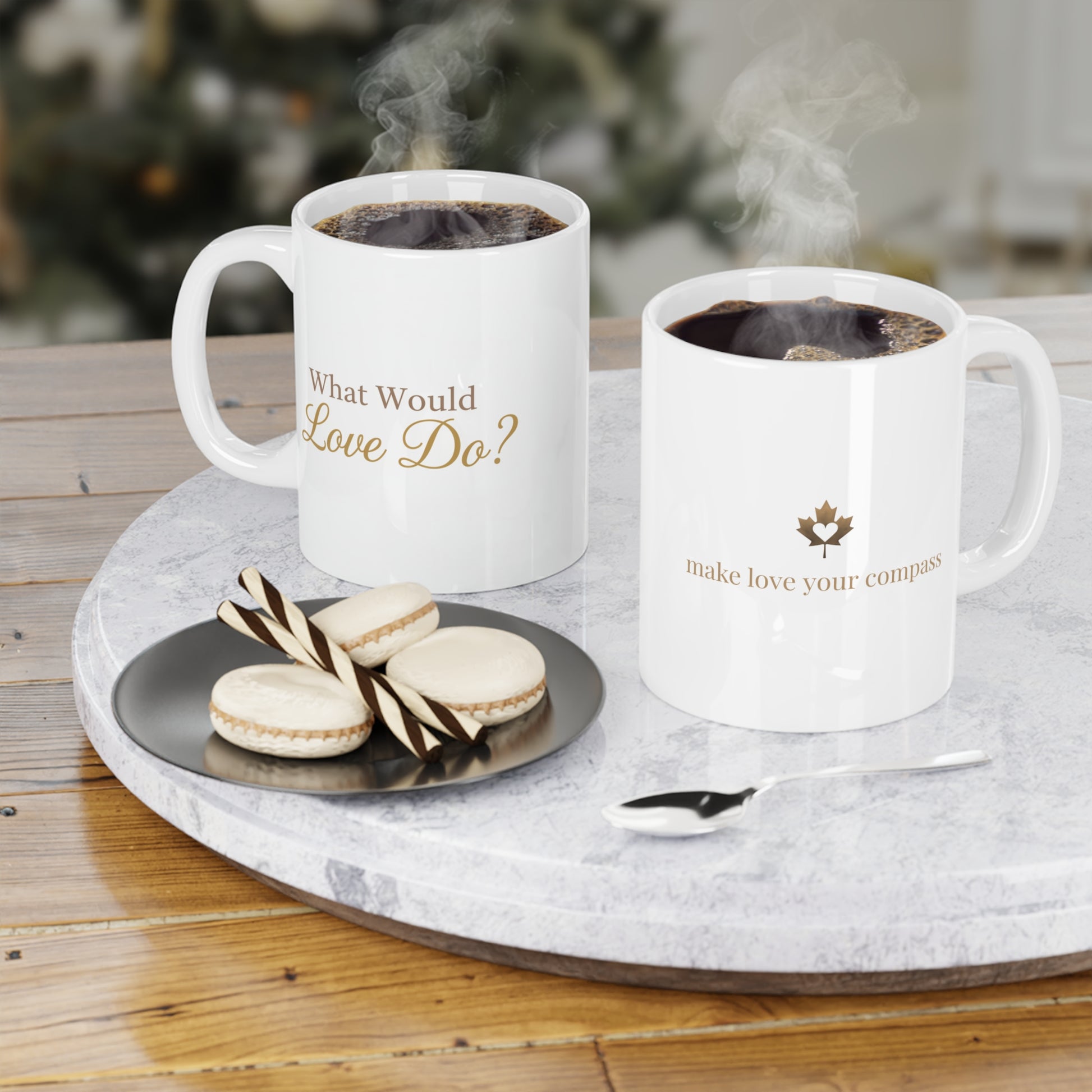 Two mugs with coffee and cookies on a marble tray with a Christmas tree in the background.