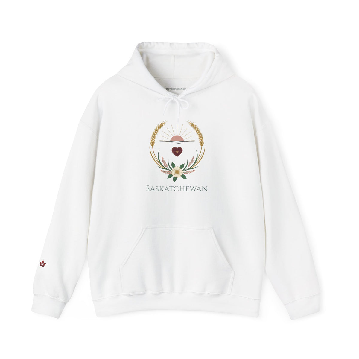 A white pullover hoodie featuring a central graphic of a white deer head surrounded by golden wheat and green leaves, with the word 'SASKATCHEWAN' printed below. A small red maple leaf graphic is visible on the left sleeve.