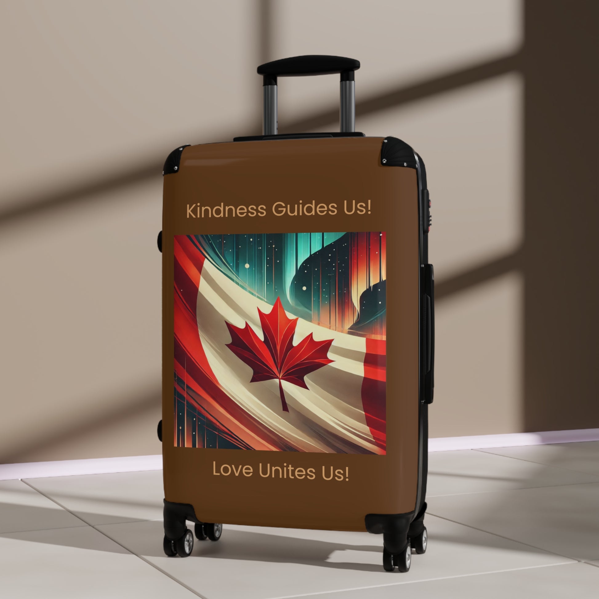 Brown rolling suitcase featuring a Canadian flag and maple leaf design with the words “Kindness Guides Us!” and “Love Unites Us!” from the Make Love Your Compass™ Canadian Collection.