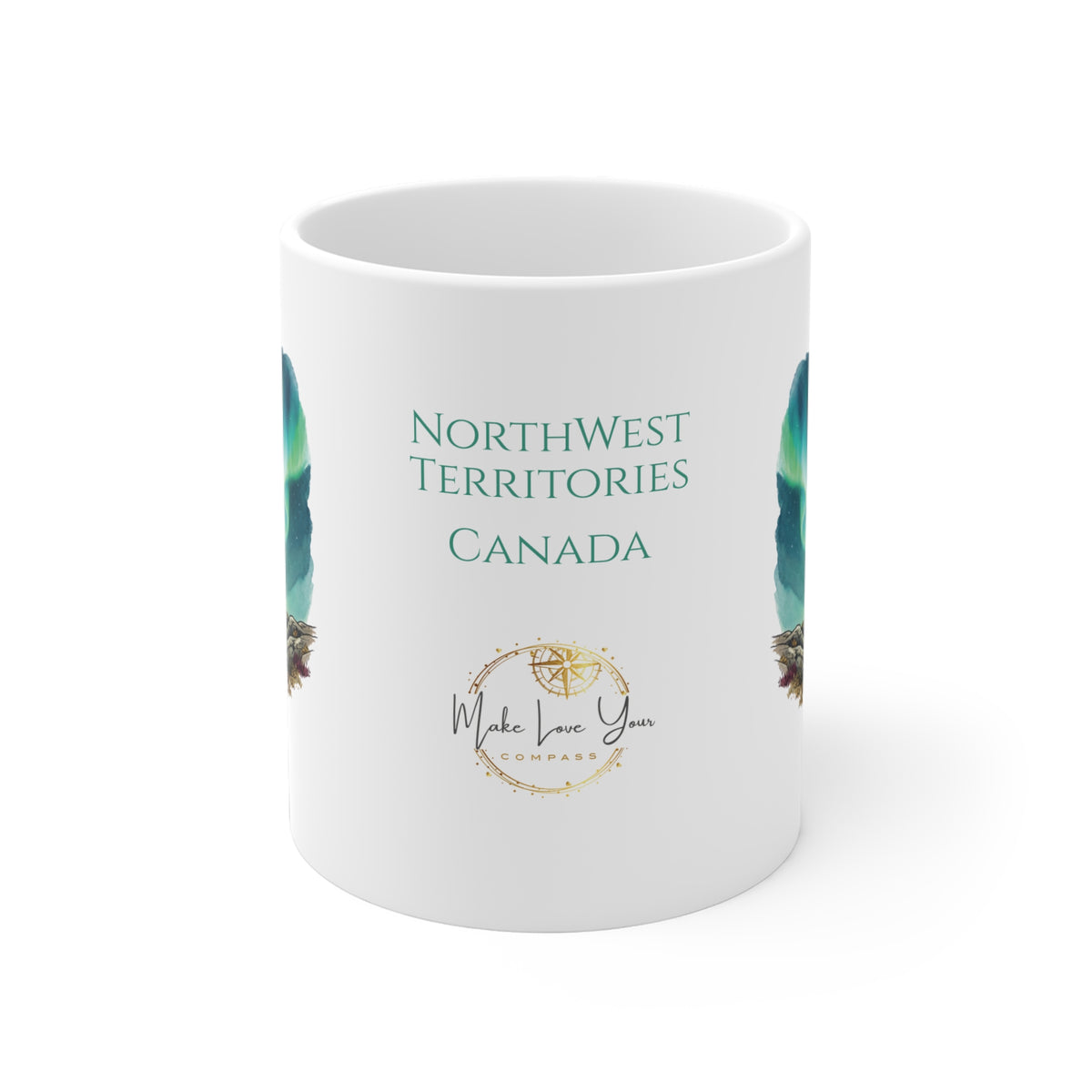 A white ceramic mug featuring the text 'NORTHWEST TERRITORIES CANADA' in teal, a gold compass design, and a circular 'Make Love You Compass' logo, with partial teal and brown feather illustrations on the sides.