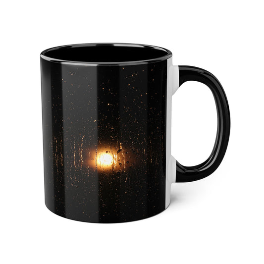 Black mug with a glowing light bulb design on a white background