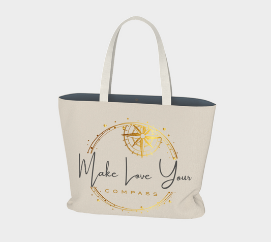 Beige tote bag with gold and black text and design on a white background