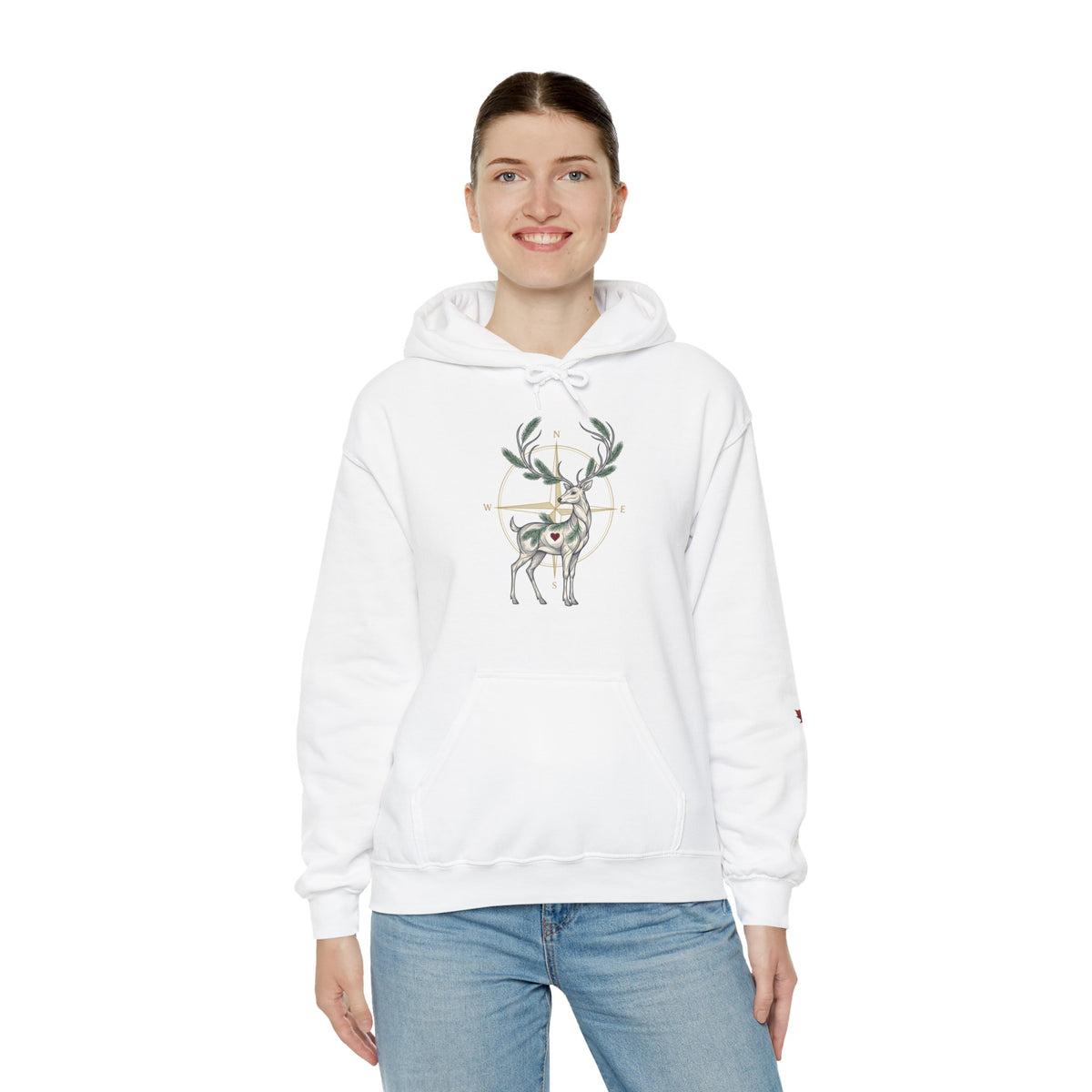 A woman wearing a white pullover hoodie featuring a deer graphic inside a target design on the chest, paired with blue jeans, against a plain white background.