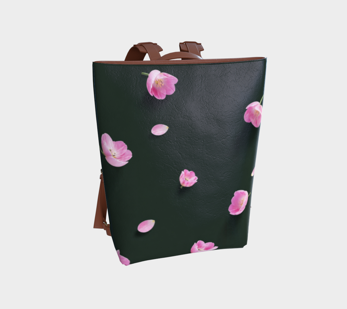A dark green faux-leather tote bag with pink cherry blossom flowers and petals printed on the front, featuring brown leather handles and side straps, shown against a light gray background.