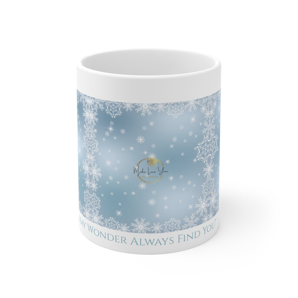 A white ceramic mug featuring a light blue winter-themed wrap design with white snowflakes, a central gold circular logo, and the text 'MAY WONDER ALWAYS FIND YOU™' printed along the bottom edge.