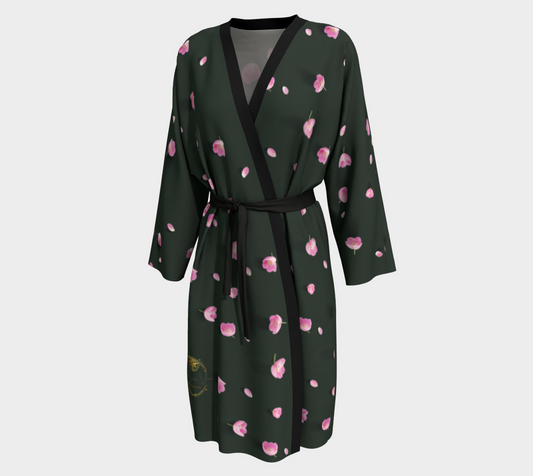 A dark green kimono-style robe with a pink floral print, black trim along the V-neck and waist tie belt, and a small gold emblem near the lower left hem, shown on a light gray background.
